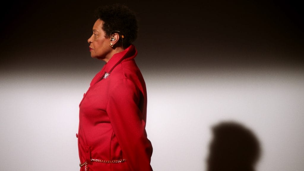 A woman wearing a red suit. 
