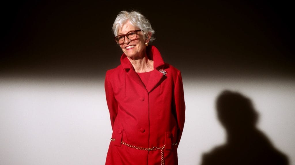 A woman wearing a red suit. 