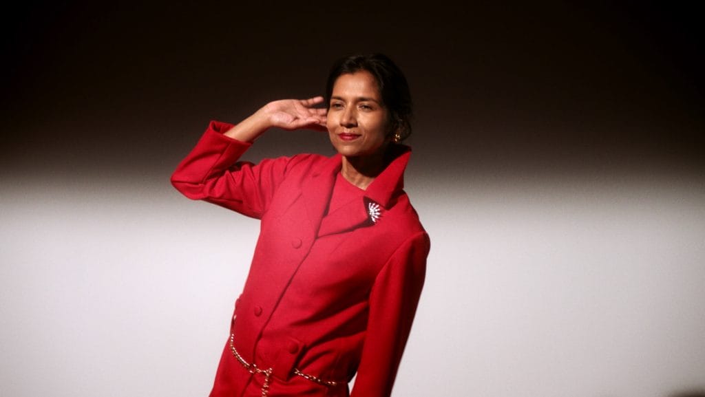 A woman wearing a red suit. 