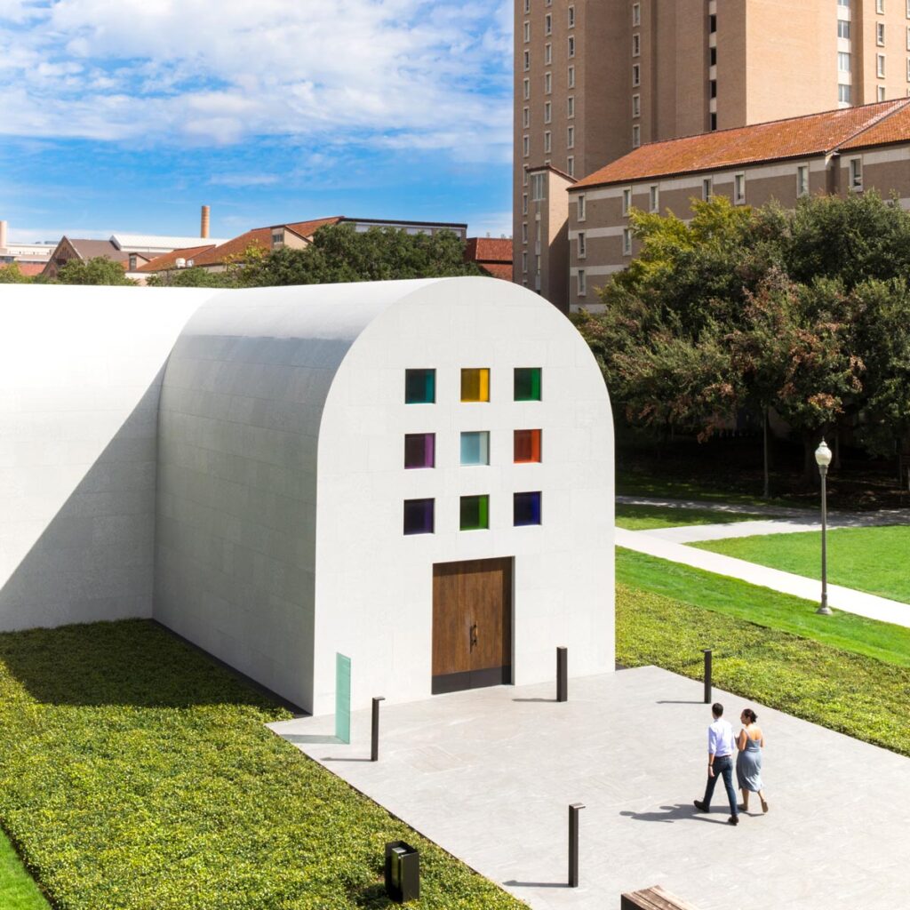 Midday bird's eye view shot of the entrance of Austin by Ellsworth Kelly with Jester Dormitory in the background. Two visitors are approaching door.