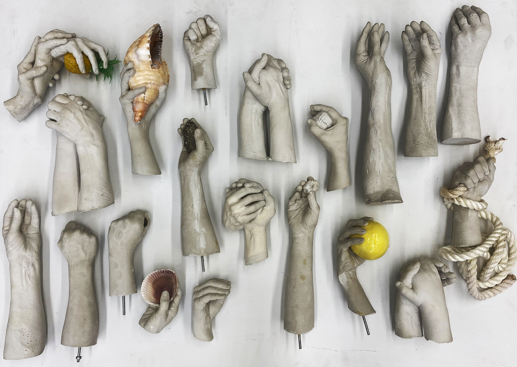 Las Hermanas Iglesias, works in progress, 2022, hands of the artists and their family members, cast in plaster; various objects.