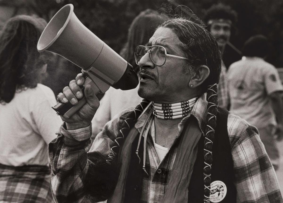 Alan Pogue, “Raul Salinas with bullhorn. Anti-police brutality march. Austin, Texas, 1981,“ Gelatin silver print, Gift of Gilberto Cárdenas and Dolores Garcia, 2023.217. Featured in Pt. 2 of De moda.