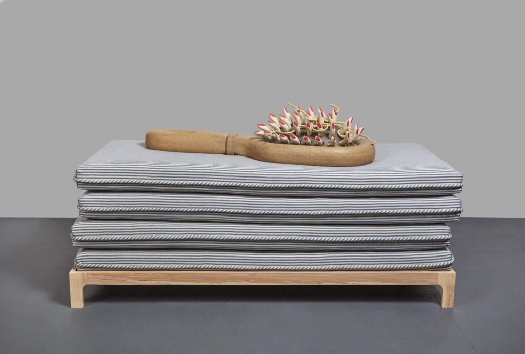 Genesis Belanger, "Big Sleep," 2019, Stoneware and porcelain, ash, cotton ticking, and foam, Overall: 45 × 60 × 23 in., Collection of Deborah & James Kern (Photograph Pauline Shapiro, Courtesy François Ghebaly)
