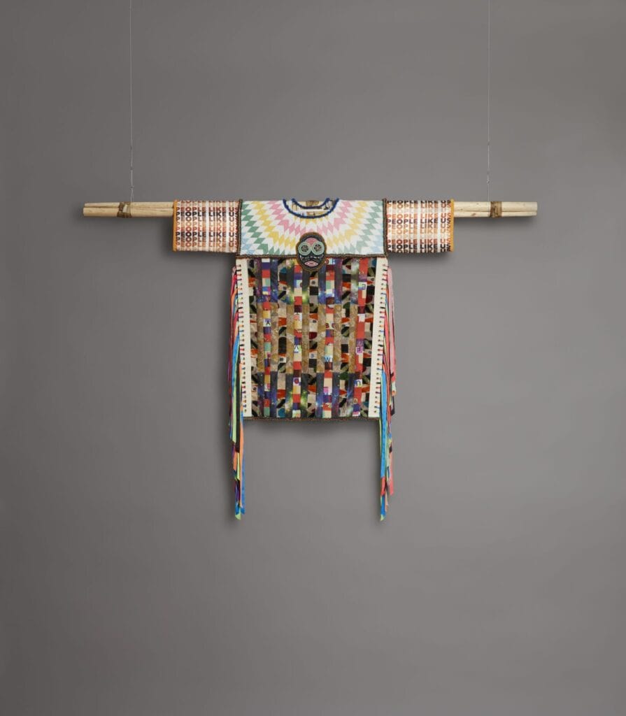 Jeffrey Gibson, "People Like Us," 2018, custom-printed polyester satin and neoprene, cotton, silk Ikat velvet, wool, and repurposed quilt, tapestry, and vestment, with glass, plastic, and stone beads, nickel and brass studs, brass grommets, cultured pearls, nylon ribbon, and artificial sinew on tipi poles, 85 × 74 × 5 in., Blanton Museum of Art, The University of Texas at Austin, Purchase through the generosity of the Meinig Family Foundation and the Alturas Foundation, 2019.143 Courtesy of the artist and Roberts Projects, Los Angeles, California. Photo: Peter Mauney