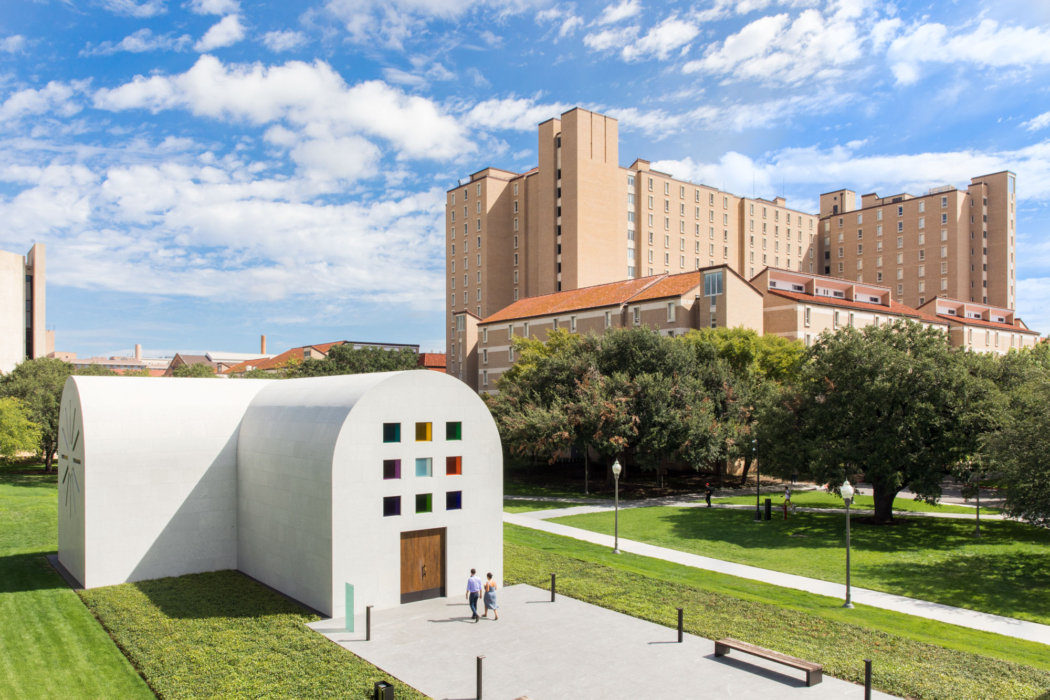 Midday bird's eye view shot of the entrance of Austin by Ellsworth Kelly with Jester Dormitory in the background. Two visitors are approaching door.