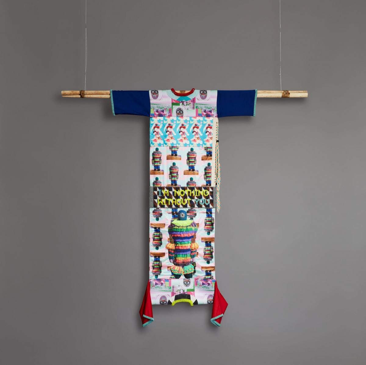 Jeffrey Gibson, Without You I’m Nothing, 2018, Custom-printed polyester satin and neoprene, polyester, and batting, with glass, plastic, stone, and bone beads, brass grommets, acrylic yarn, polyester laces, acrylic paint, and artificial sinew on acrylic felt and canvas, suspended from tipi poles with rawhide ties, 121 x 74 1/4 x 7 1/2 in. (307.3 x 188.6 x 19.1 cm). Courtesy of the artist; Roberts Projects, Los Angeles; Sikkema Jenkins & Co., New York; and Kavi Gupta, Chicago. © Jeffrey Gibson.