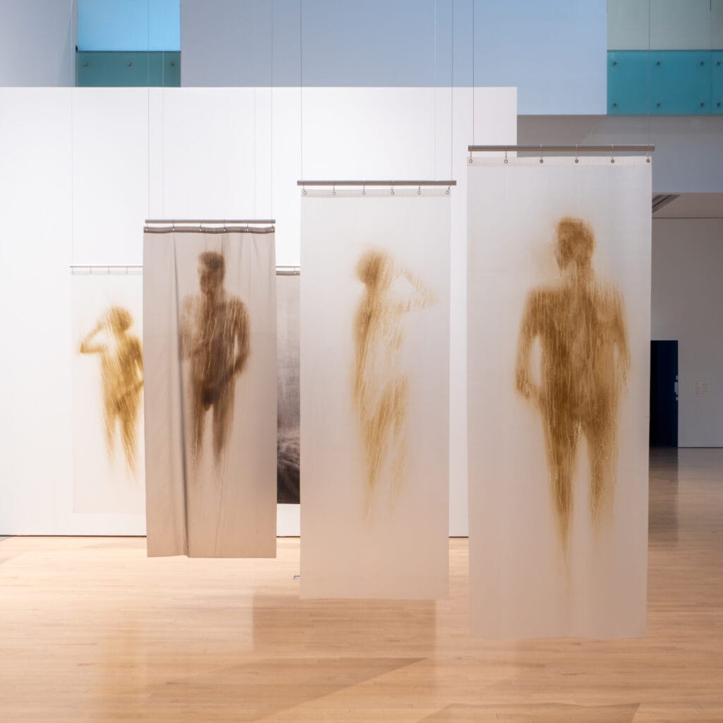 Oscar Muñoz, "Shower Curtains," acrylic on plastic, variable dimensions. Installation view from Oscar Muñoz: Invisibilia, 2021, Phoenix Art Museum. Courtesy of Phoenix Art Museum. 