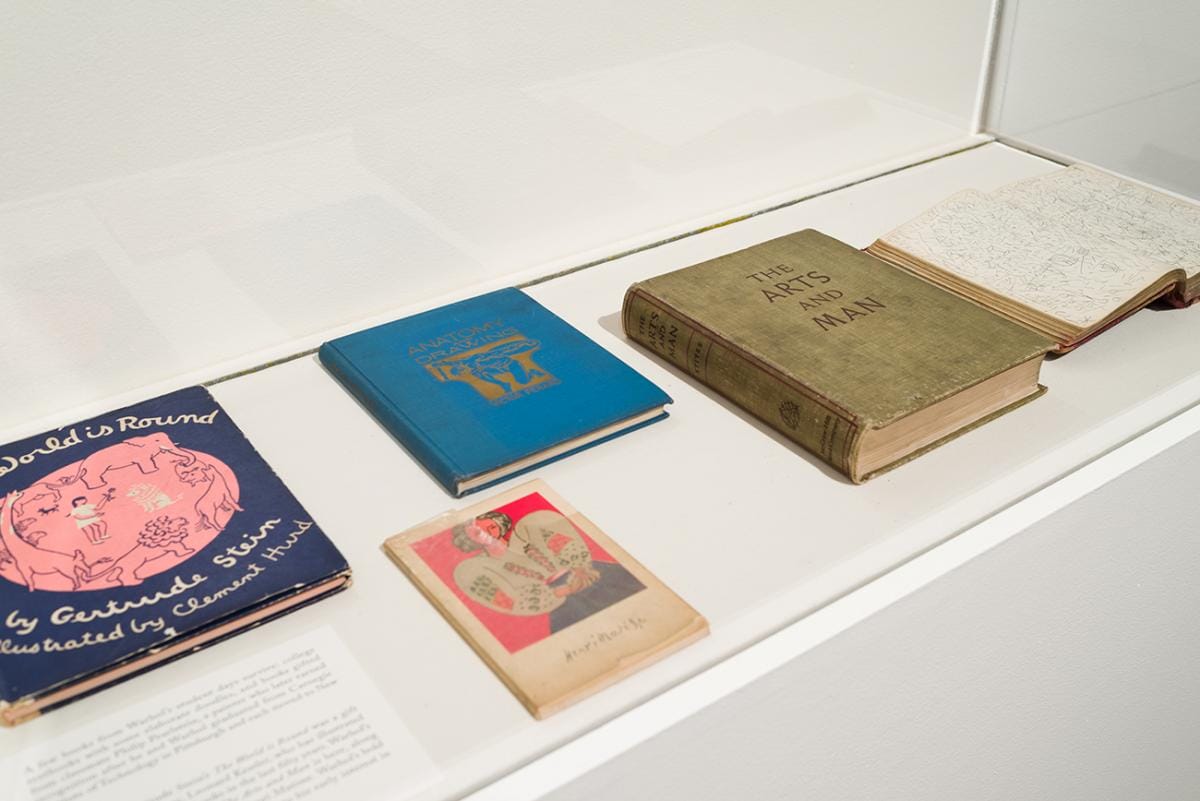 Printed books in a display case.