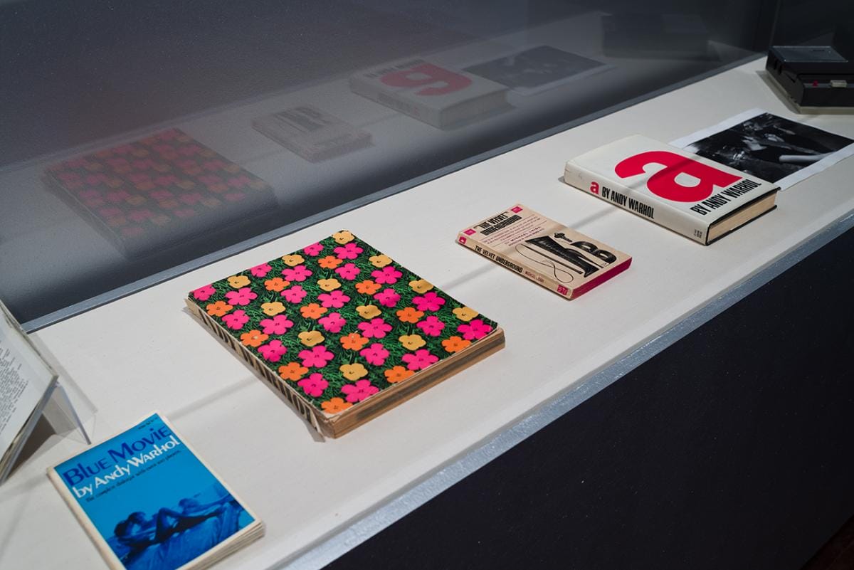 Printed books in a display case.