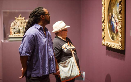 Older couple admiring a large artwork.